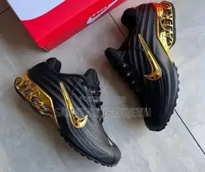 Black Nike Sneakers with Glossy Upper & Gold Swoosh