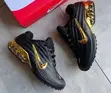 Black Nike Sneakers with Glossy Upper & Gold Swoosh - 1