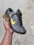 Black Nike Sneakers with Glossy Upper & Gold Swoosh - 2