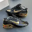 Black Nike Sneakers with Glossy Upper & Gold Swoosh - 3