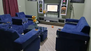 Royal Comfort 7-Seater Blue Velvet Sofa with Cup Holder & Glass Table